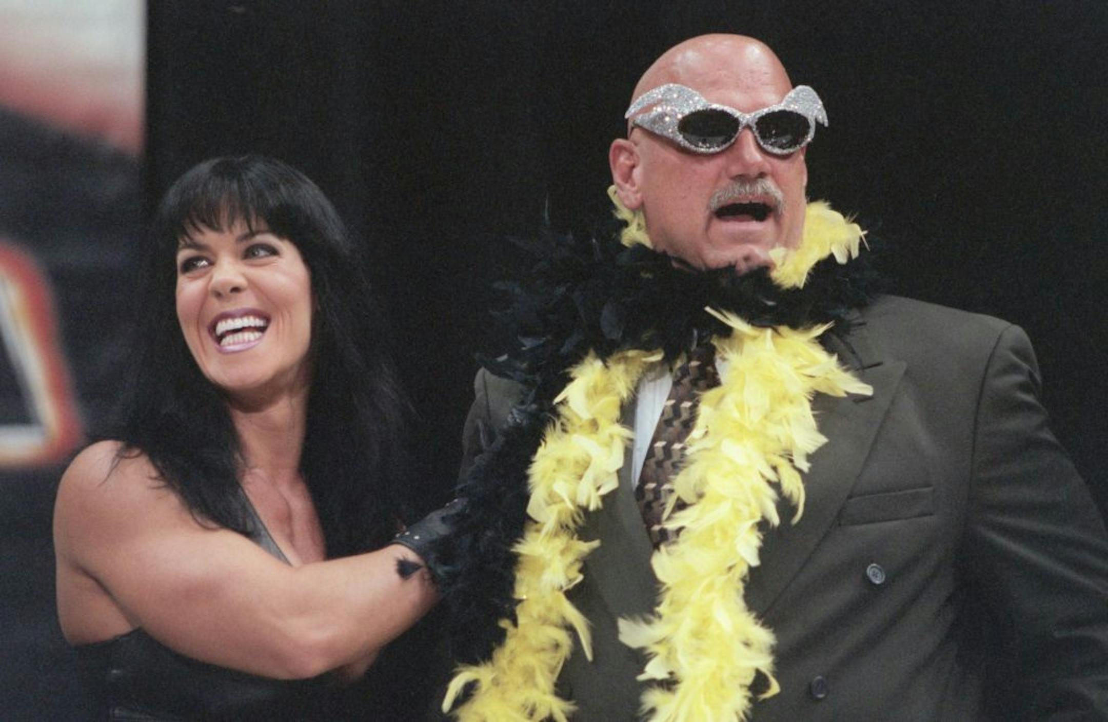 FILE -- Chyna places a feather boa on then-Gov. Jesse Ventura, during a press conference July 14, 1999 at the Target Center in Minneapolis to announce that Jesse �The Body� Ventura would referee a WWF championship match.