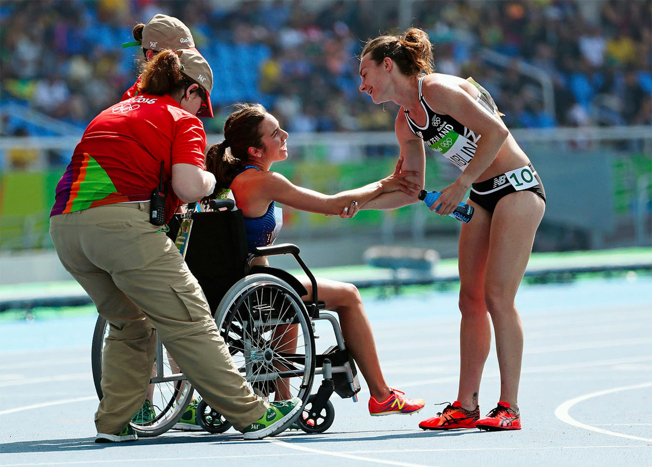 OLY BEST GALLERY FOR MONDAY- New Zealand's Nikki Hamblin reaches out a hand of thanks to USA's Abbey D'agostino (in chair) after the two tangled and fell during the 5,000 race heats and despite a torn ACL D'agostino stayed back to help Hamblin up. A pure sign of sportsmanship in a sea of competition.