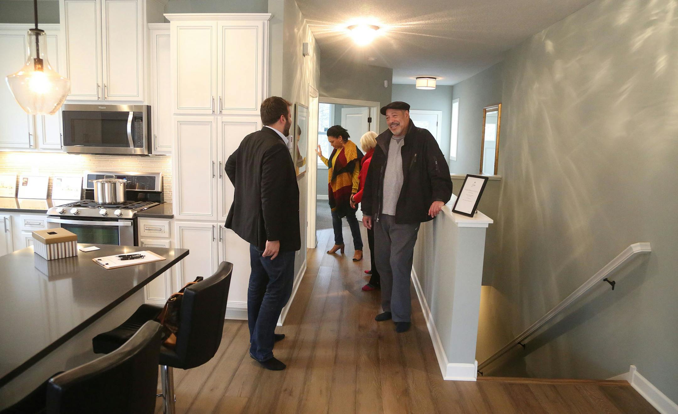 Jason Stockwell and Diane Eldredge, sales agents with Remax Result, hosted an open house at new 4 bedroom, 3 bath 3,300 square foot rambler in Roseville, one of 18 similar units built by a non-profit developer. Here, Stockwell, left, and Eldredge, second from right, show off the unit to Gary Allen, right, and his wife Sylvia Allen, second from left, of Minnetrista, who showed a high interest in the unit.]
(DAVID JOLES/STARTRIBUNE)djoles@startribune.com Did a spike in mortgate rates deter home bu
