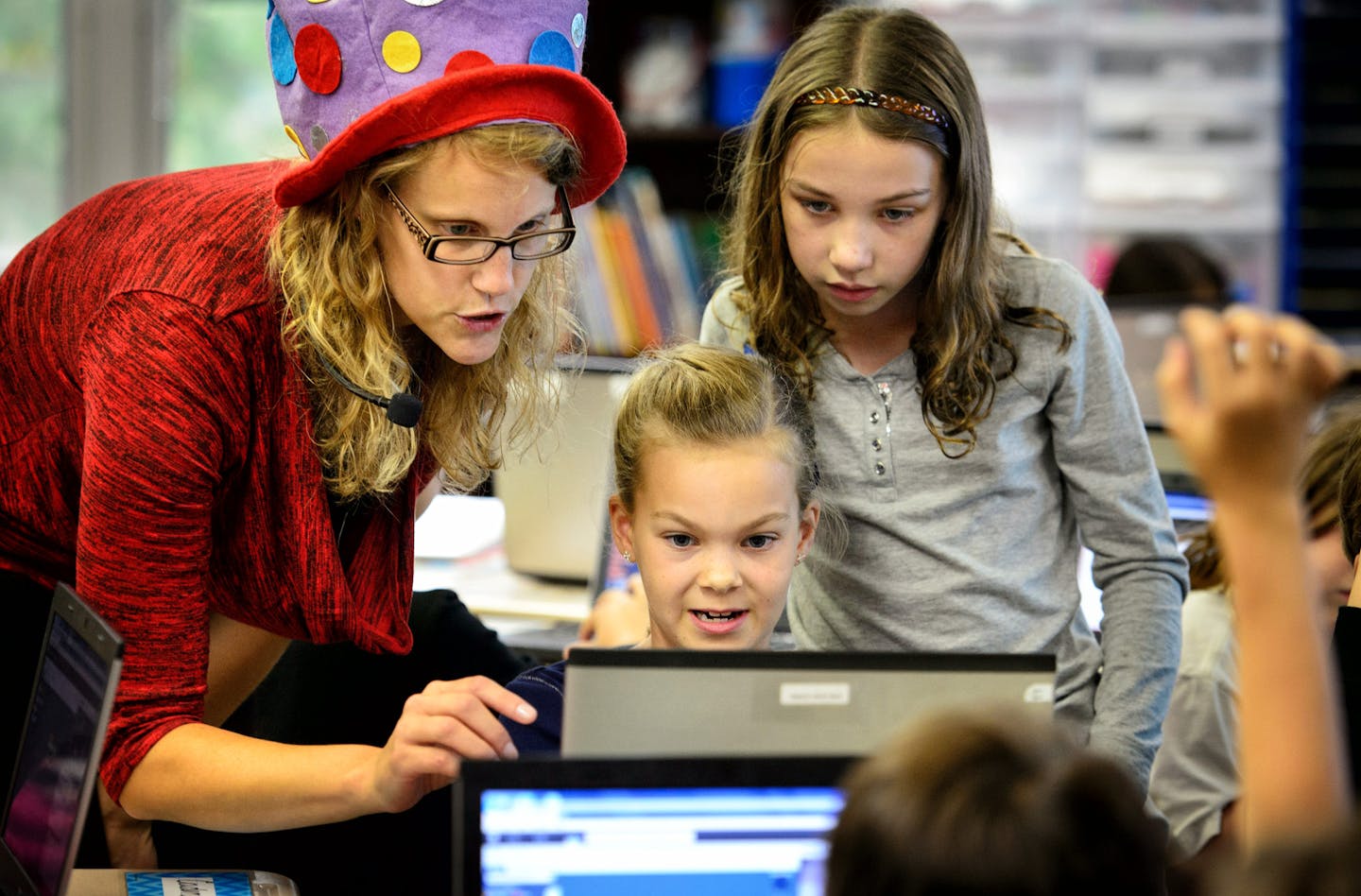 At Deephaven Elementary School Spanish fourth grade emersion teacher Kirsten Lunzer worked with students Clara Foster and Julia Srnec on a challenging aspect of coding. She wears a polkadot hat when speaking in English and the hat comes off when she speaks Spanish. ] Thursday, September 25, 2014