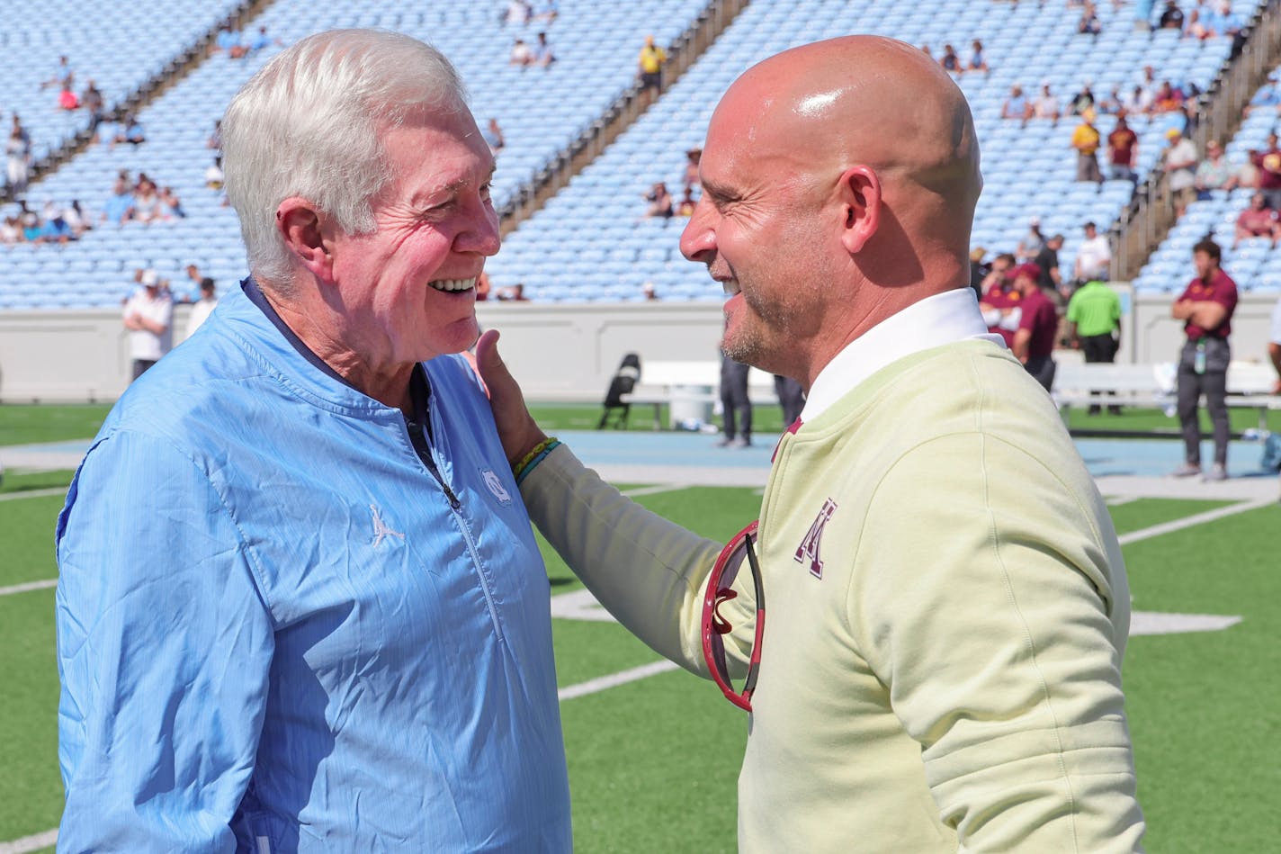 Gophers coach P.J. Fleck, right, talked with North Carolina coach Mack Brown at mid field before Saturday's game