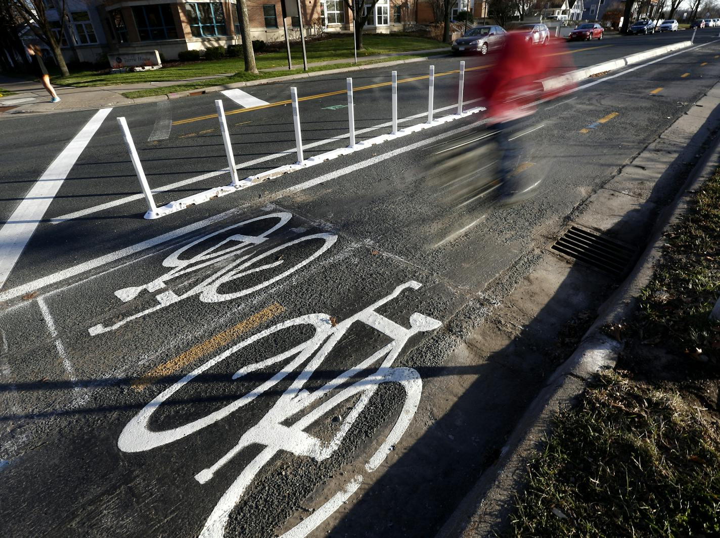 A cyclist rode along a bike trail on Oak St. SE near the University of Minnesota in Minneapolis. ] CARLOS GONZALEZ &#xef; cgonzalez@startribune.com - November 23, 2015, Minneapolis, MN, Mark 2015 down as the year when a new type of bike lane intended to get the Twin Cities pedaling more took off in Minneapolis. Not only did the city adopted its first plan to added protected bike lanes, but it also added enough of them to start out on pace to hit the goal of 30 new miles of the protected lanes by