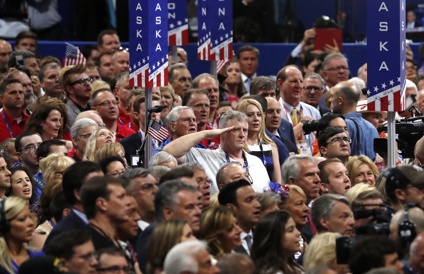 A man salutes during the singing of the National Anthem on the final day of the Republican National Convention in Cleveland, Thursday, July 21, 2016. (AP Photo/Paul Sancya)