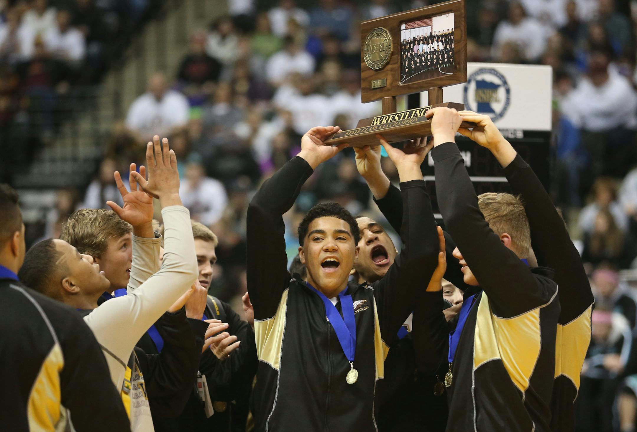 Apple Valley celebrated with their 3A state championship trophy ] (KYNDELL HARKNESS/STAR TRIBUNE) kyndell.harkness@startribune.com - 1A team State wrestling tournament at the Xcel Energy Center in St. Paul Thursday, February 27, 2014.