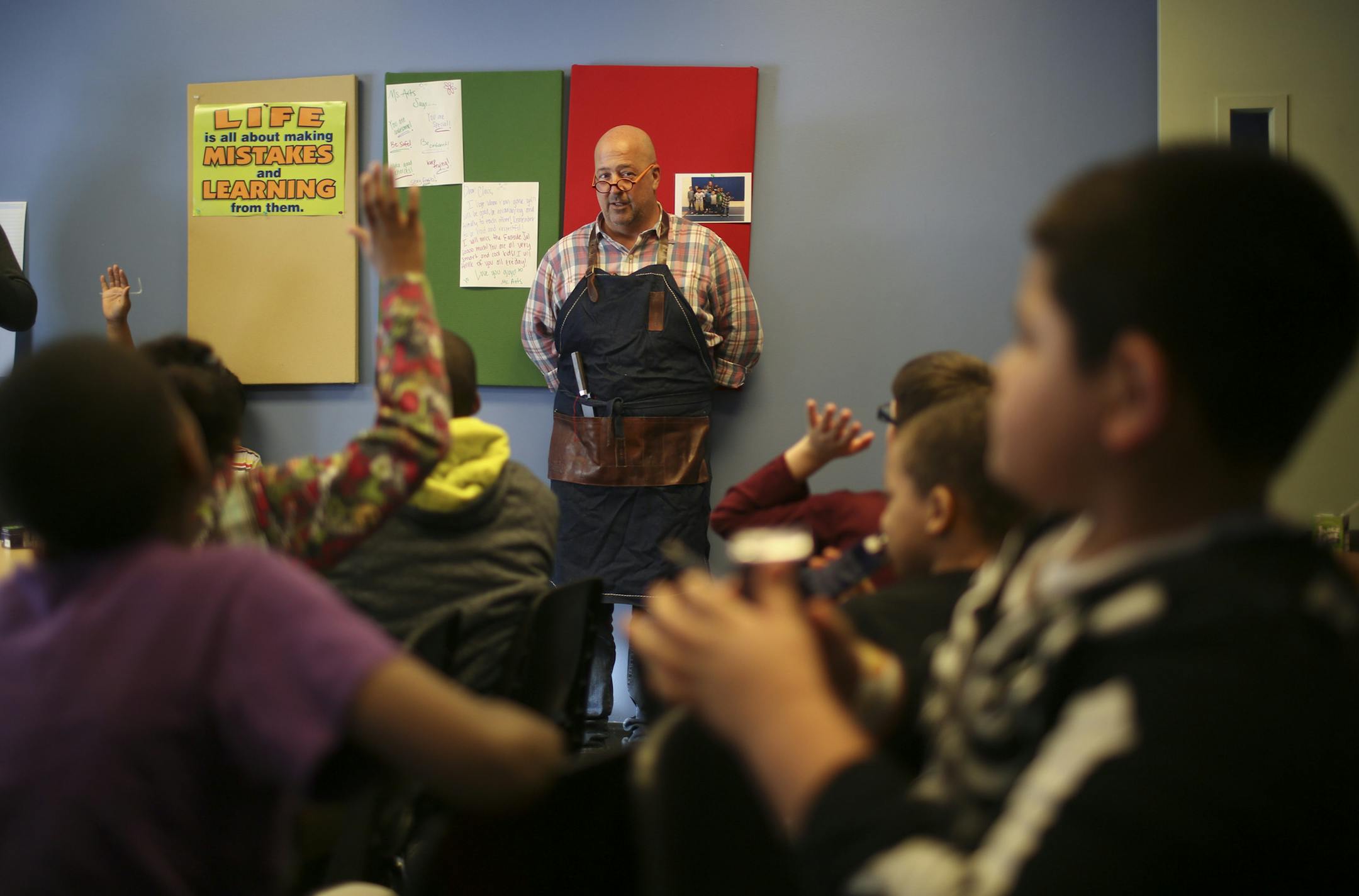 Travel Channel host (and Twin Cities resident) Andrew Zimmern stopped by the Salvation Army's Payne Ave. location in St. Paul to cook with chef Jeff Ansorge, former head chef at the Captal Grille in Minneapolis, as he prepared a meal Monday afternoon, March 3, 2014 for donors and volunteers. Antwan Zimmern asked all the kids who helped make posters (to thank him for his visit) to raise their hands when he dropped by to visit with Antwan Flowers' after school program at the Salvation Army's Easts