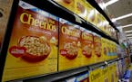 FILE- In this Aug. 8, 2018, file photo boxes of General Mills Honey Nut Cheerios cereal sit on display in a market in Pittsburgh. General Mills Inc. r