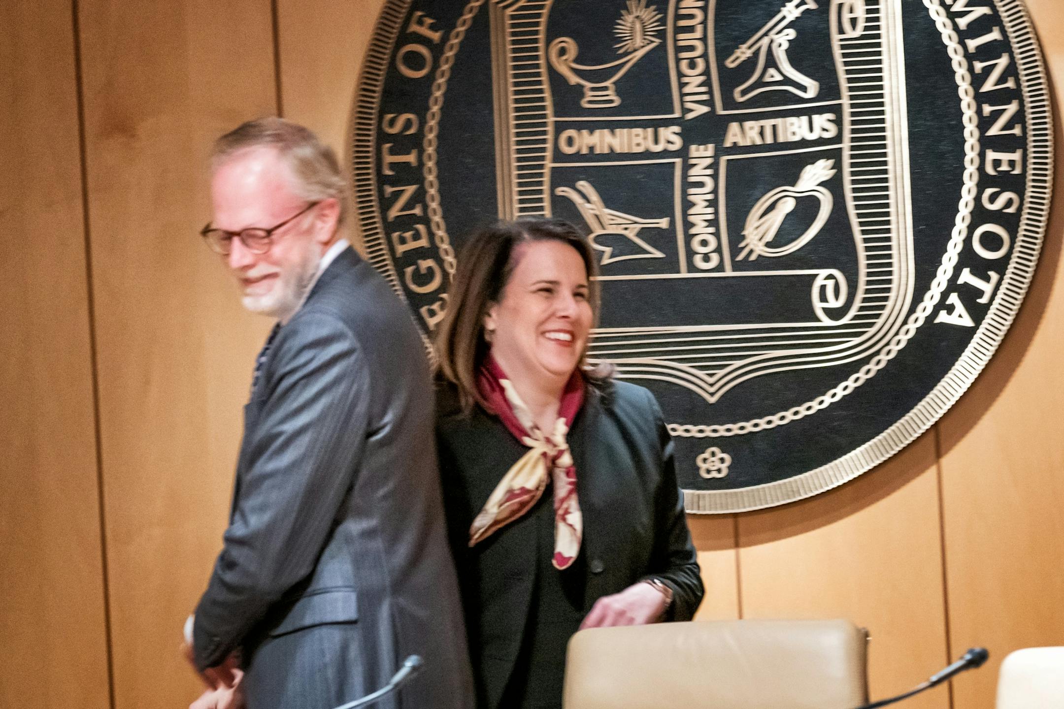Joan Gabel rose to greet members of the Board of Regents after they unanimously voted to hire her as the university's first female president. Here she greeted David McMillan, Chair of the Board.