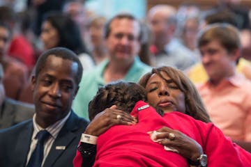 Minnehaha Academy President Donna Harris hugged ninth-grader Alexis Stanley as she arrived for a prayer service Wednesday night after an explosion at 