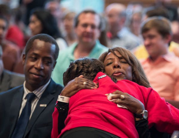 Minnehaha Academy President Donna Harris hugged ninth-grader Alexis Stanley as she arrived for a prayer service Wednesday night after an explosion at 