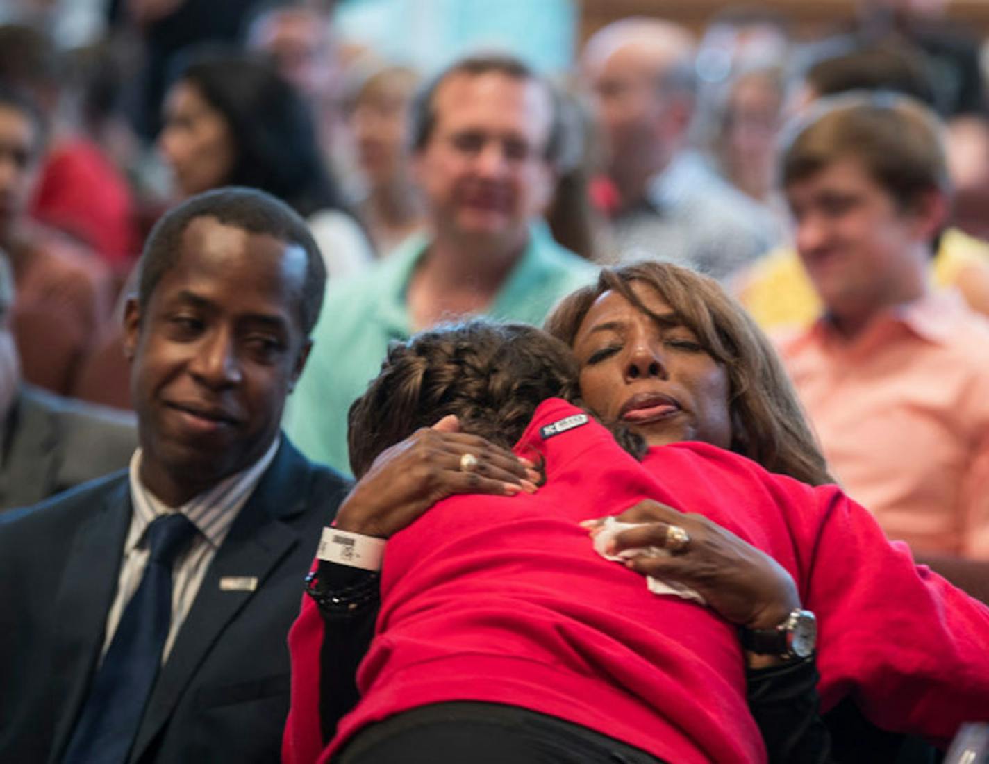 Minnehaha Academy President Donna Harris hugged ninth-grader Alexis Stanley as she arrived for a prayer service Wednesday night after an explosion at the school in Minneapolis.