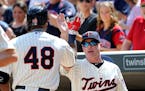 Torii Hunter gets a high five from manager Paul Molitor.
