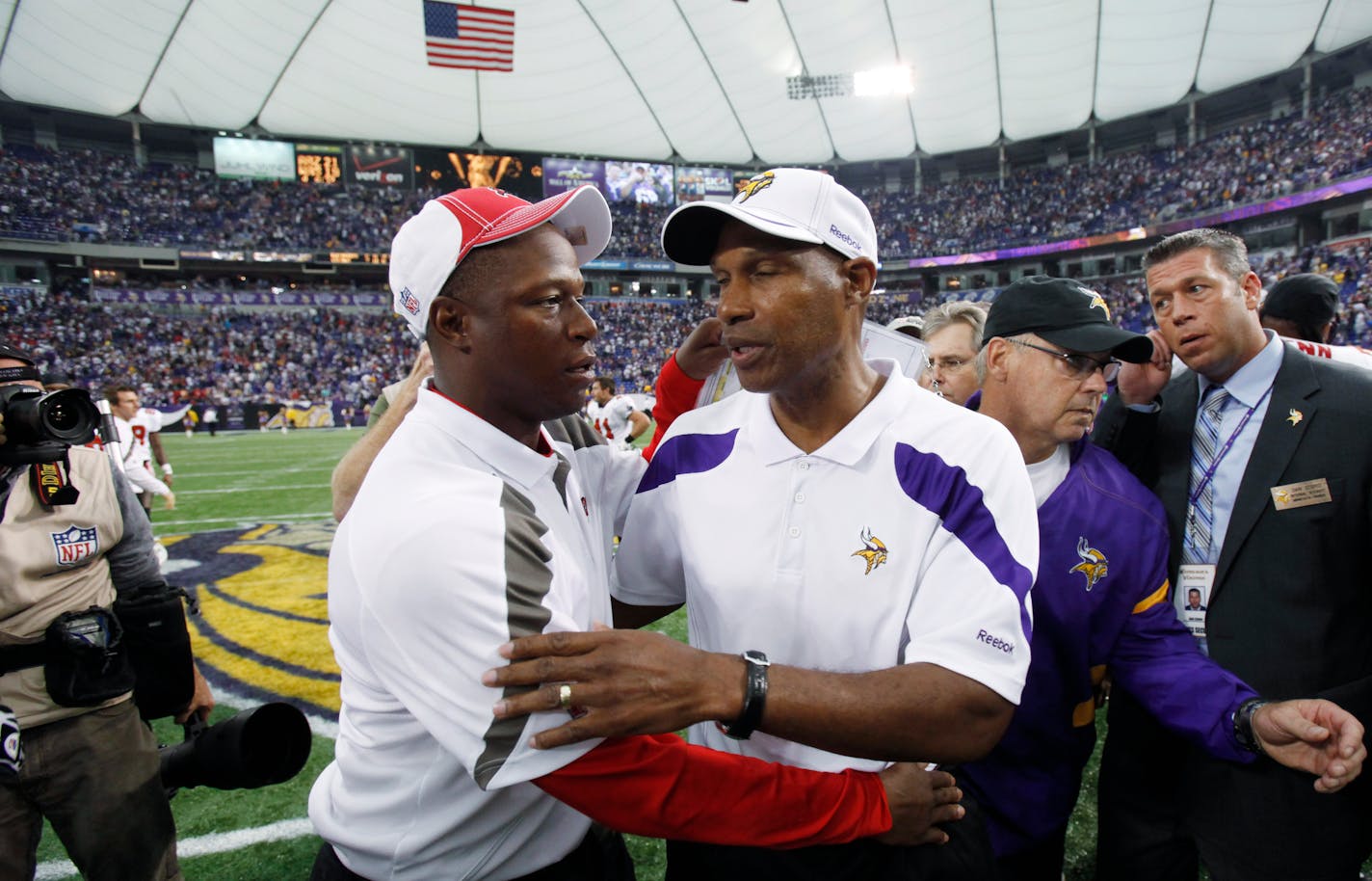 Tampa Bay Buccaneers coach Raheem Morris, left, and Minnesota Vikings coach Leslie Frazier