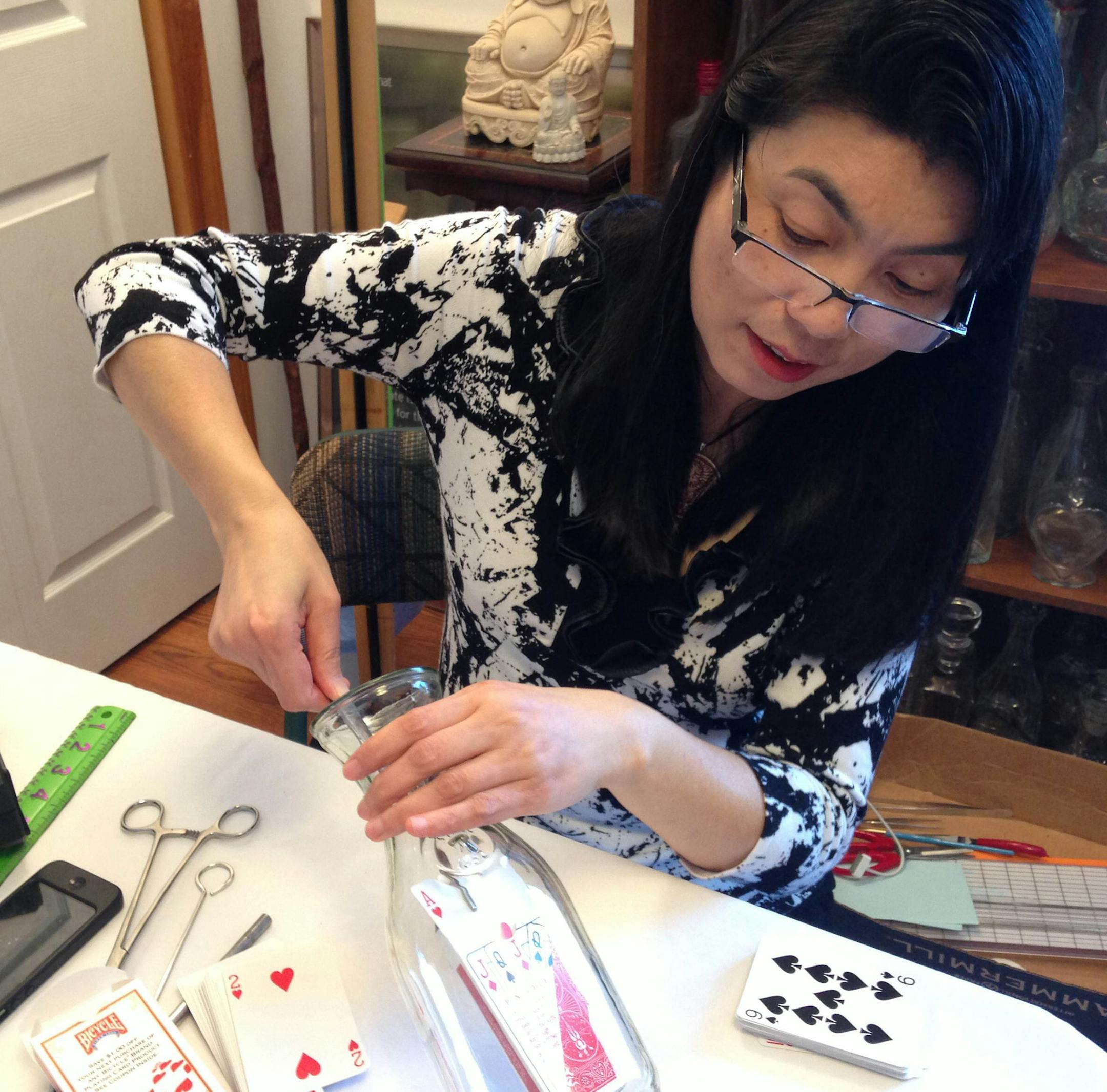 Kathy Brown demonstrates the patience required in making an "impossible bottle." Brown published a second edition of "The Love Story of Impossible Bottles" as a way to remember and pay tribute to her late husband, Chris Brown, who died in a skydiving accident in 2012. (Photo provided) ORG XMIT: 1163803