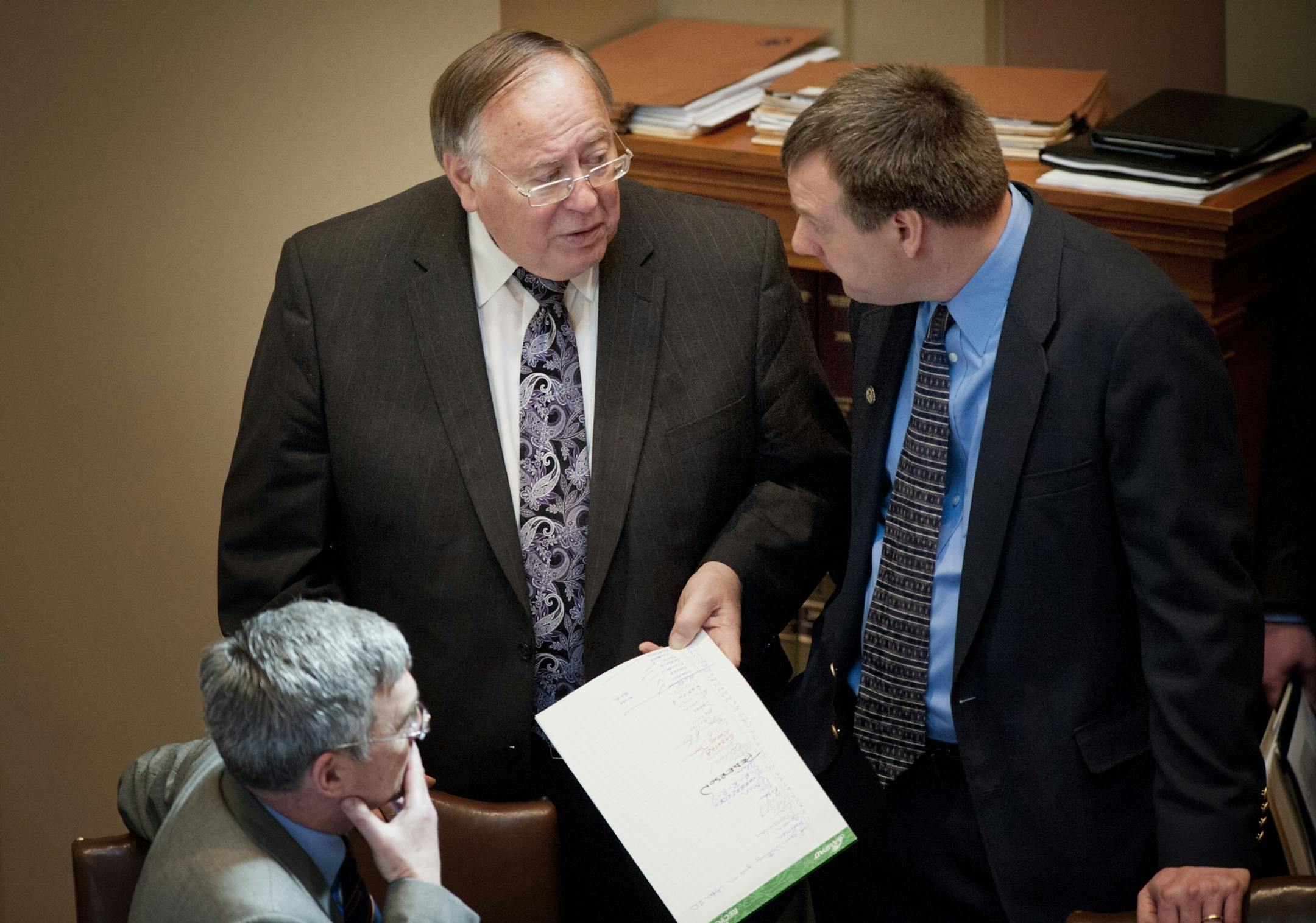 Senate Majority Leader David Senjem (R) held a legal pad with names of senators who would vote yes on Voter ID as he spoke with Sen. David Hamm (R) and Sen. Chris Gerlach (R) on the Senate floor as Voter ID was discussed. Wednesday, April 4, 2012.