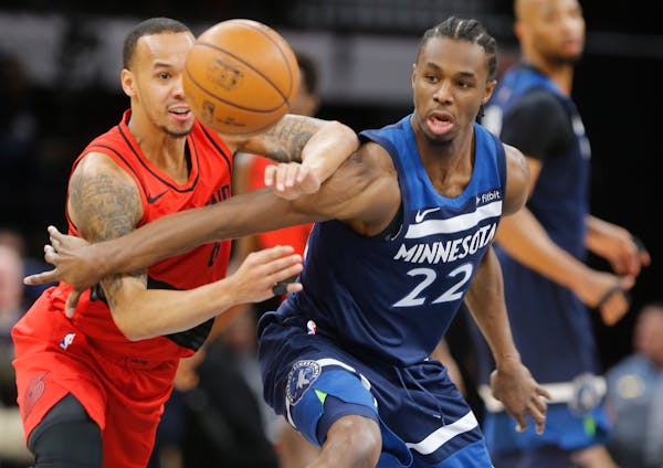 Sabazz Napier looks to steal the ball from Andrew Wiggins