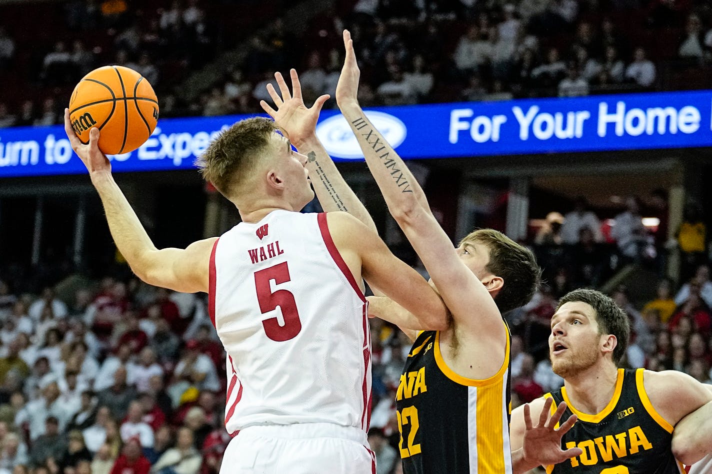 Wisconsin's Tyler Wahl (5) shoots against Iowa's Patrick McCaffery (22) during the second half of an NCAA college basketball game Wednesday, Feb. 22, 2023, in Madison, Wis. (AP Photo/Andy Manis)