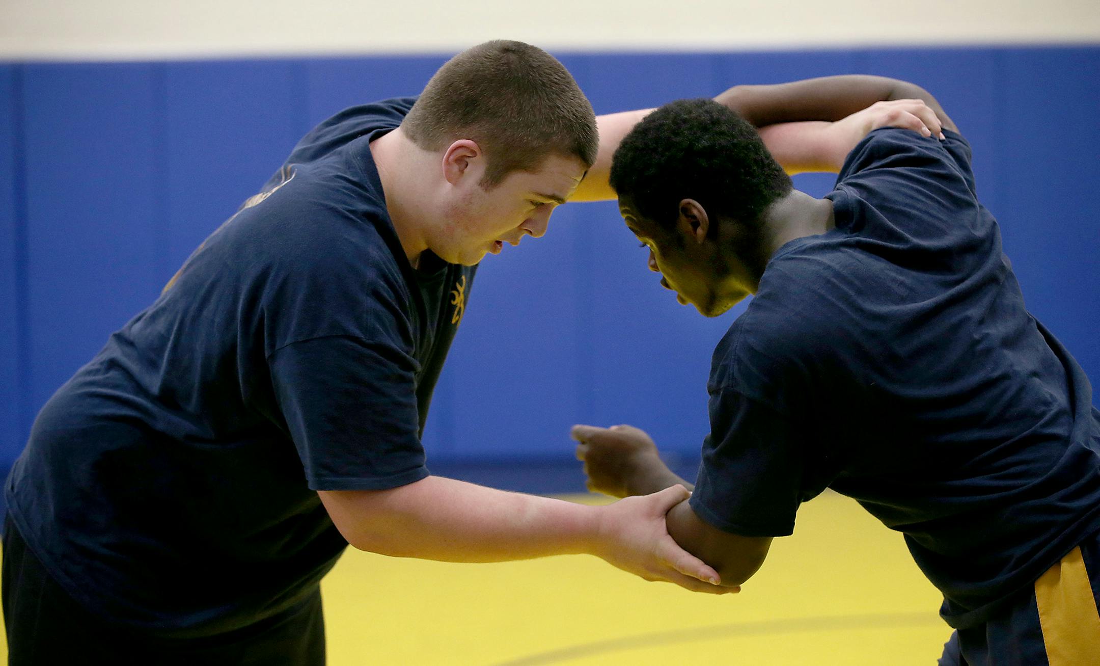 Totino-Grace wrestlers including Sam Anderson, left, and Kez Flomo practiced Thursday, February 19, 2015 in Fridley, MN. The team has qualified for state, largely on the strength of its heavier-weight wrestlers. ] (ELIZABETH FLORES/STAR TRIBUNE) ELIZABETH FLORES • eflores@startribune.com