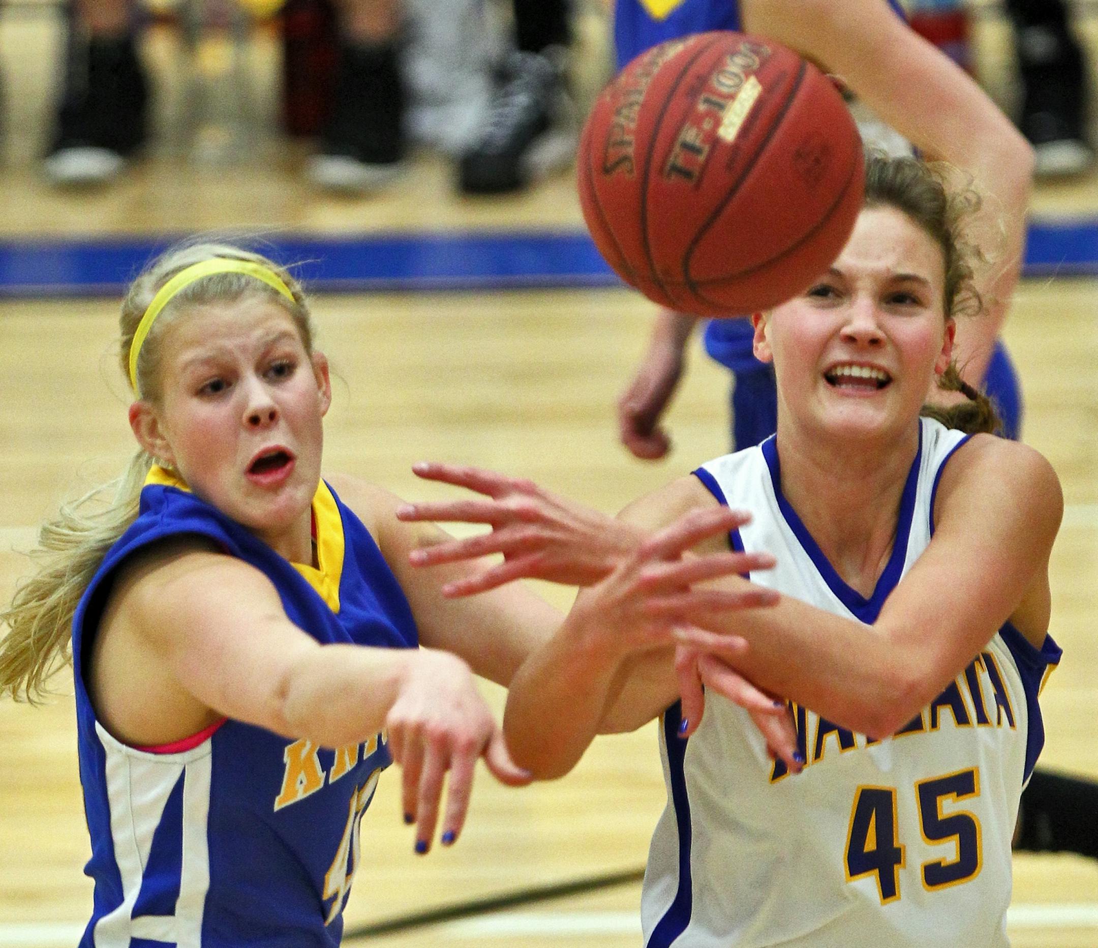 STMA's Nicole Westrum, left, and Wayzata's Reilly Johnson competed for control of a rebound.