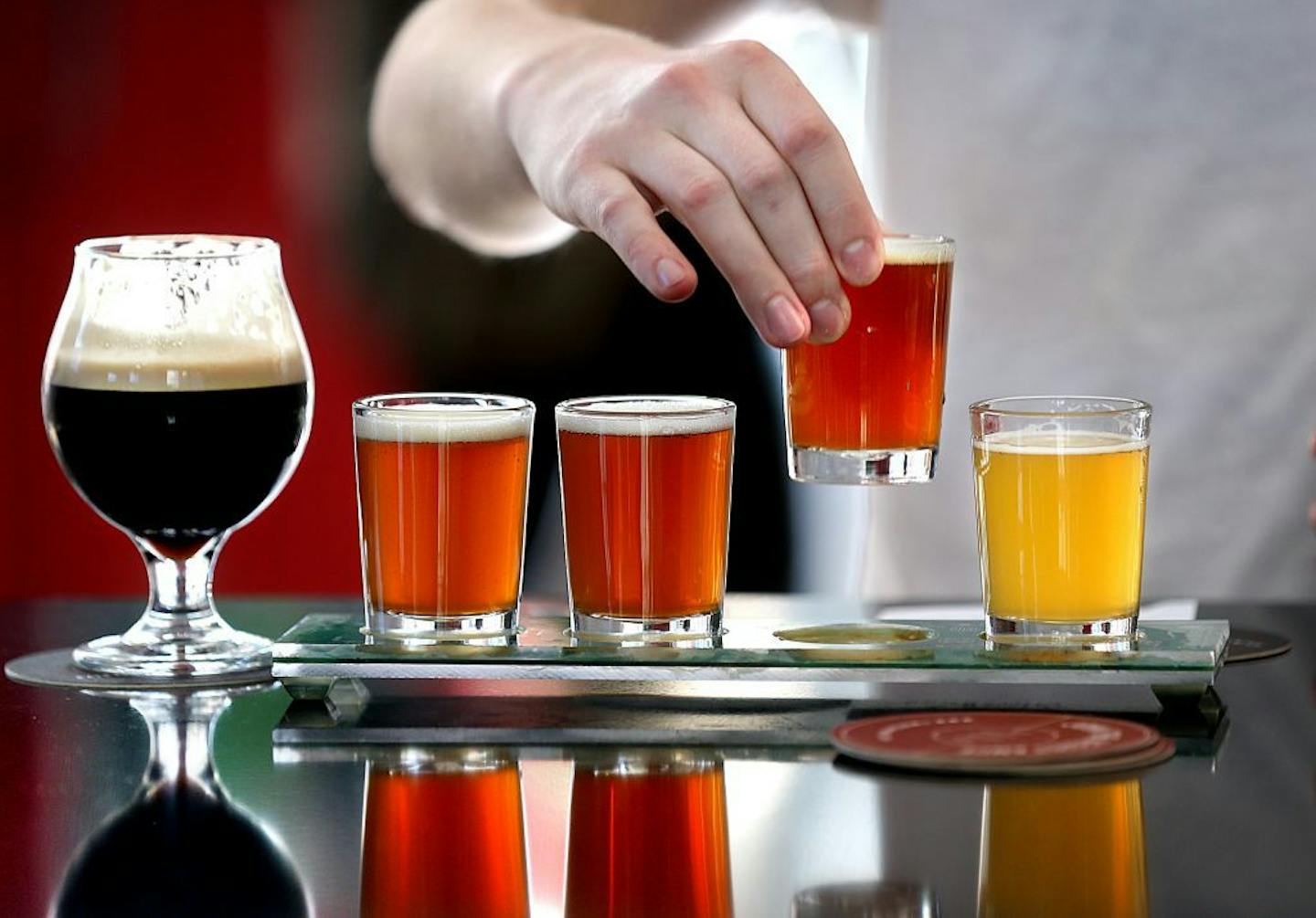 Tyler Petersen, Minneapolis, tasted a sampler of beers at the Tin Whiskers Brewing Company after yoga class. Beers included (R to L): Wheatstone, IPA (in hand)., Amber and Cask IPA. At left is Coffee Stout.