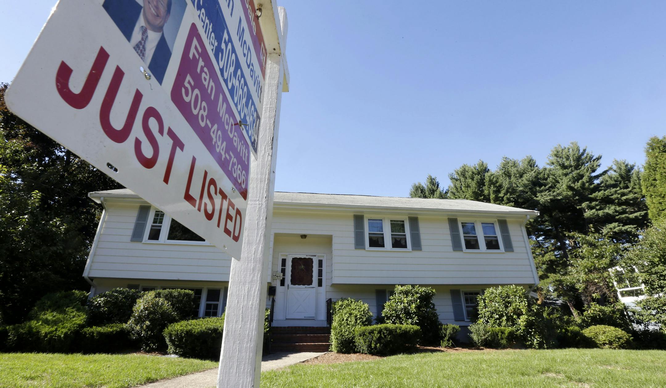 FILE - In this Wednesday, Sept. 18, 2013, file photo, a "For Sale" sign hangs in front of a house in Walpole, Mass. Americans bought fewer existing homes in September than the previous month, held back by higher mortgage rates and rising prices, the National Association of Realtors said Monday, Oct. 21, 2013. (AP Photo/Steven Senne) ORG XMIT: MIN2013102117221569