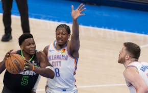 Anthony Edwards (5) of the Timberwolves is defended by Jalen Williams (8) of the Oklahoma City Thunder in the third quarter at Paycom Center in Oklaho