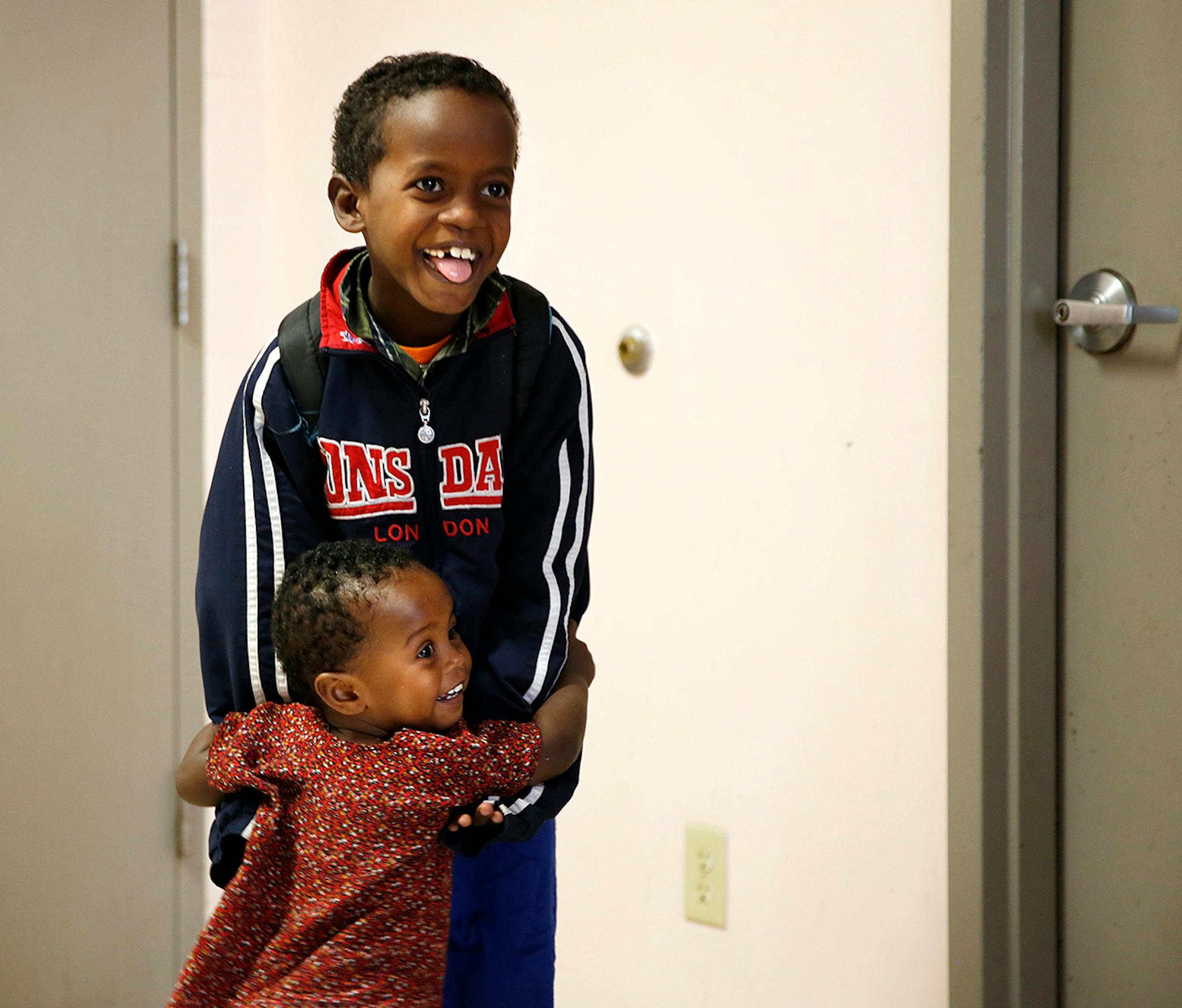 One-year-old Ikra Shukri greets her brother Shukri Shukri, 9, home from school at Mary's Place transitional apartments in downtown Minneapolis. ] LEILA NAVIDI leila.navidi@startribune.com / BACKGROUND INFORMATION: Tuesday, October 28, 2014. Minnesota has seen a marked uptick in new Somali refugee arrivals recently. The number of Somalis arriving directly from Africa has more than tripled in four years. But community leaders say there's also been an increase in so-called secondary arrivals: refug