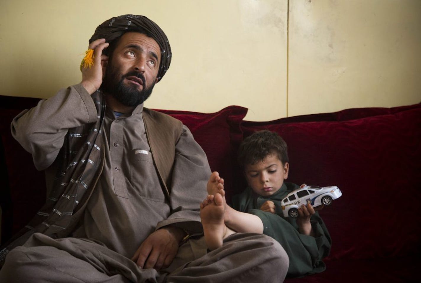 Mohammed Wazir sits with his only surviving son, Habib Shahin, 3, in Kandahar, Afghanistan on Monday, April 22, 2013 as he talks about the events of March 11, 2012 when a U.S. soldier burst into his family's home. Wazir returned to his home that morning to find 11 members of his family dead, their bodies partially burned.