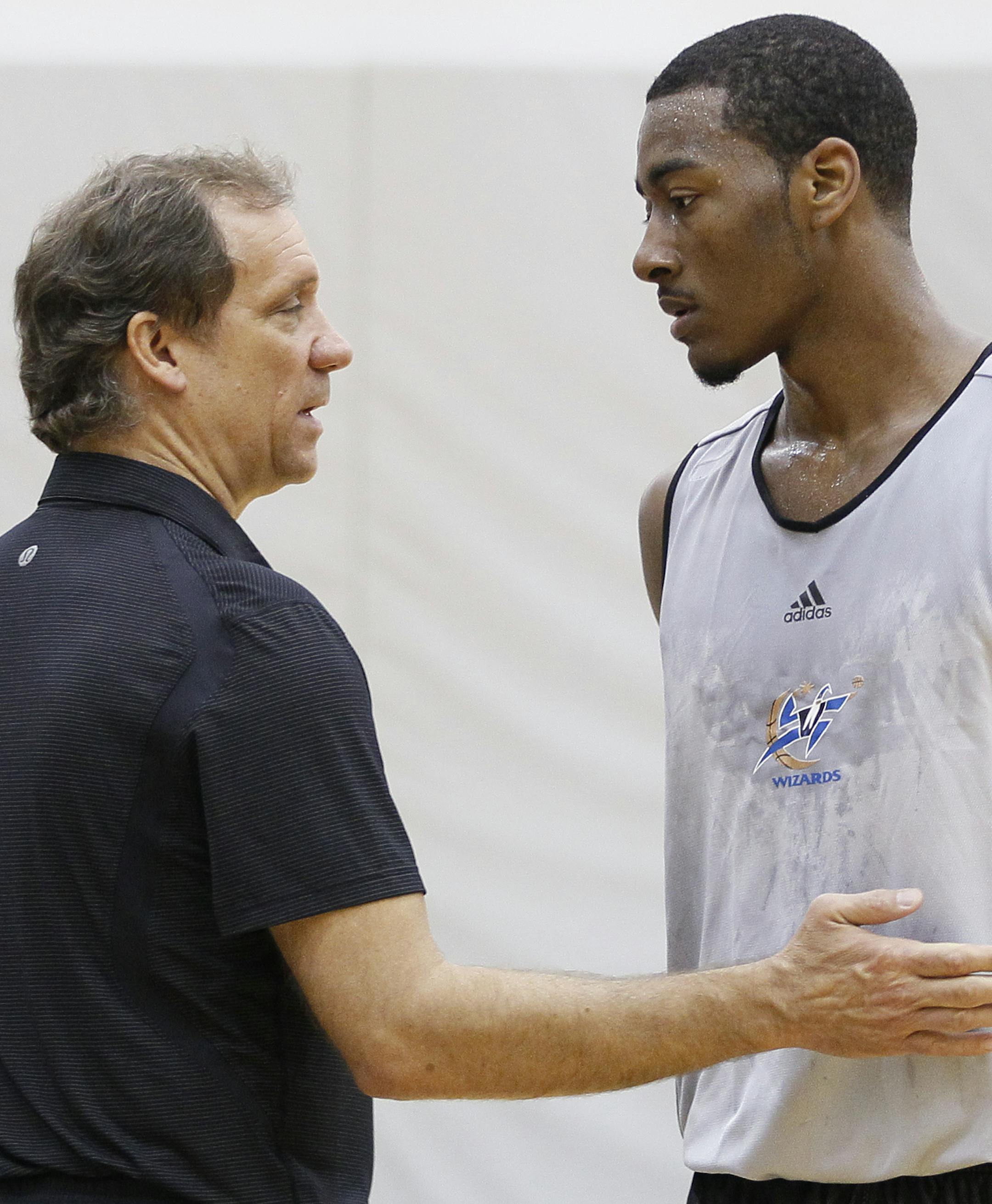 Washington Wizards basketball coach Flip Saunders, left, talks with Kentucky's John Wall during a pre-NBA draft basketball workout for the Washington Wizards, Thursday, June 17, 2010, in Washington. (AP Photo/Carolyn Kaster)