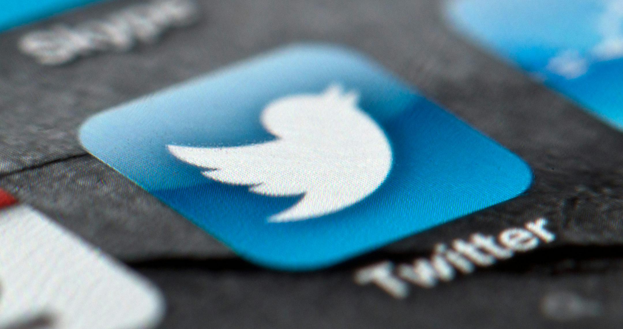 FILE - In this Feb. 2, 2013, file photo, a smartphone display shows the Twitter logo in Berlin, Germany, Twitter unsealed the documents Thursday, Oct. 3, 2013, for its planned initial public offering of stock and says it hopes to raise up to $1 billion. (AP Photo/dpa, Soeren Stache, File) ORG XMIT: MIN2013100316463352