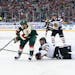 Chicago Blackhawks defenseman Brent Seabrook (7) fell to the ice while trying to steal the puck from Minnesota Wild left wing Jason Zucker (16) in the