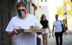 Mark Berman walked back to his North Loop home with a pizza and salad from Black Sheep in May. "I would not go to any place that offers in house dinin