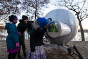 Siblings Huda Iman, 7, from left, Abdulahli, 12, and Ahlam, 10, of Roseville interact with a sculpture at Silverwood Park in St. Anthony, Minn. on Fri