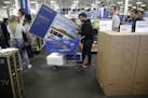 The lease-to-own program has brought new customers to Best Buy stores, said CEO Corie Barry. Above, shoppers waited in line to buy TVs at an early Bla