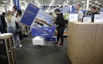The lease-to-own program has brought new customers to Best Buy stores, said CEO Corie Barry. Above, shoppers waited in line to buy TVs at an early Bla