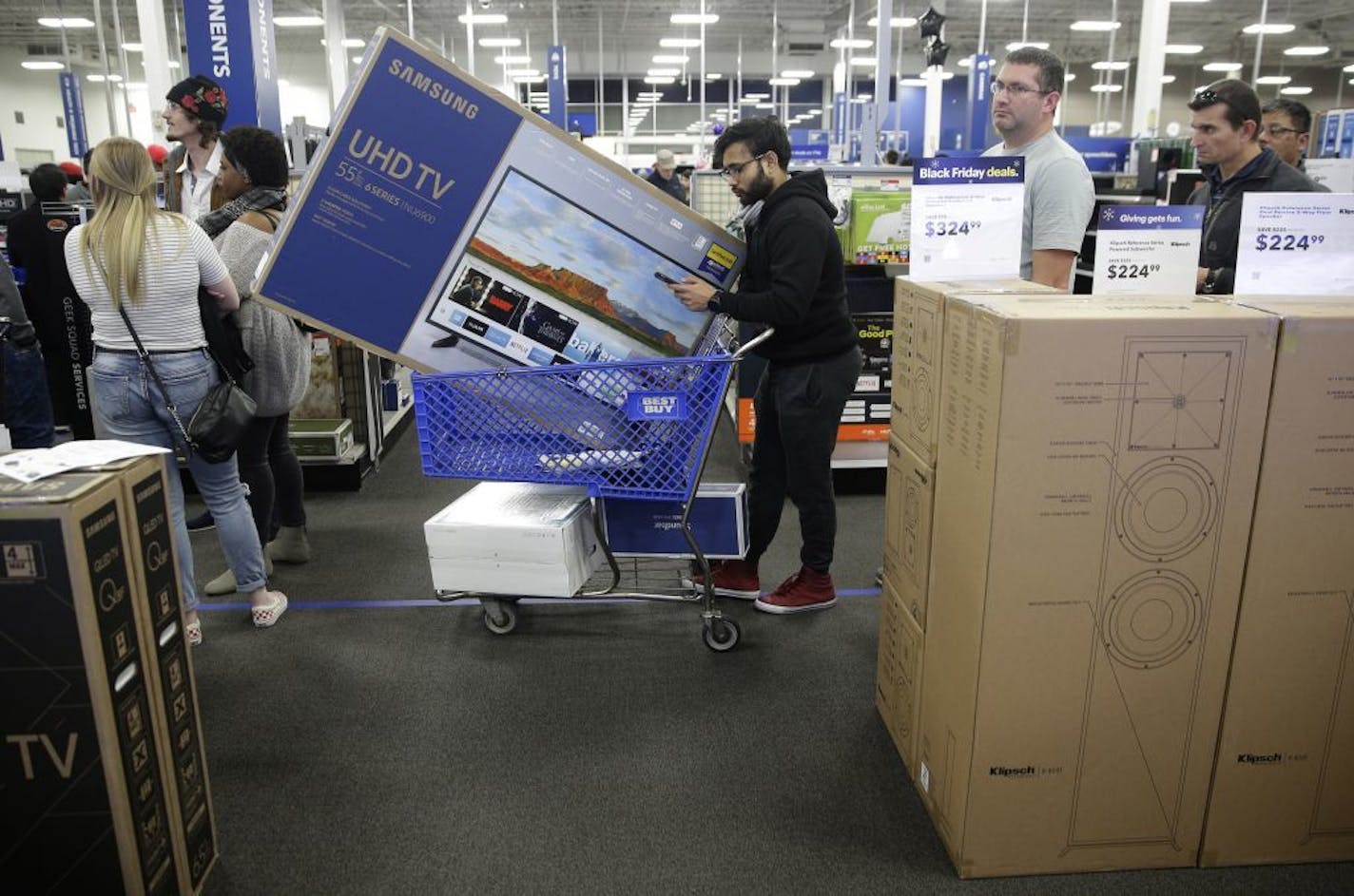 The lease-to-own program has brought new customers to Best Buy stores, said CEO Corie Barry. Above, shoppers waited in line to buy TVs at an early Black Friday sale at a Best Buy store in Overland Park, Kan.