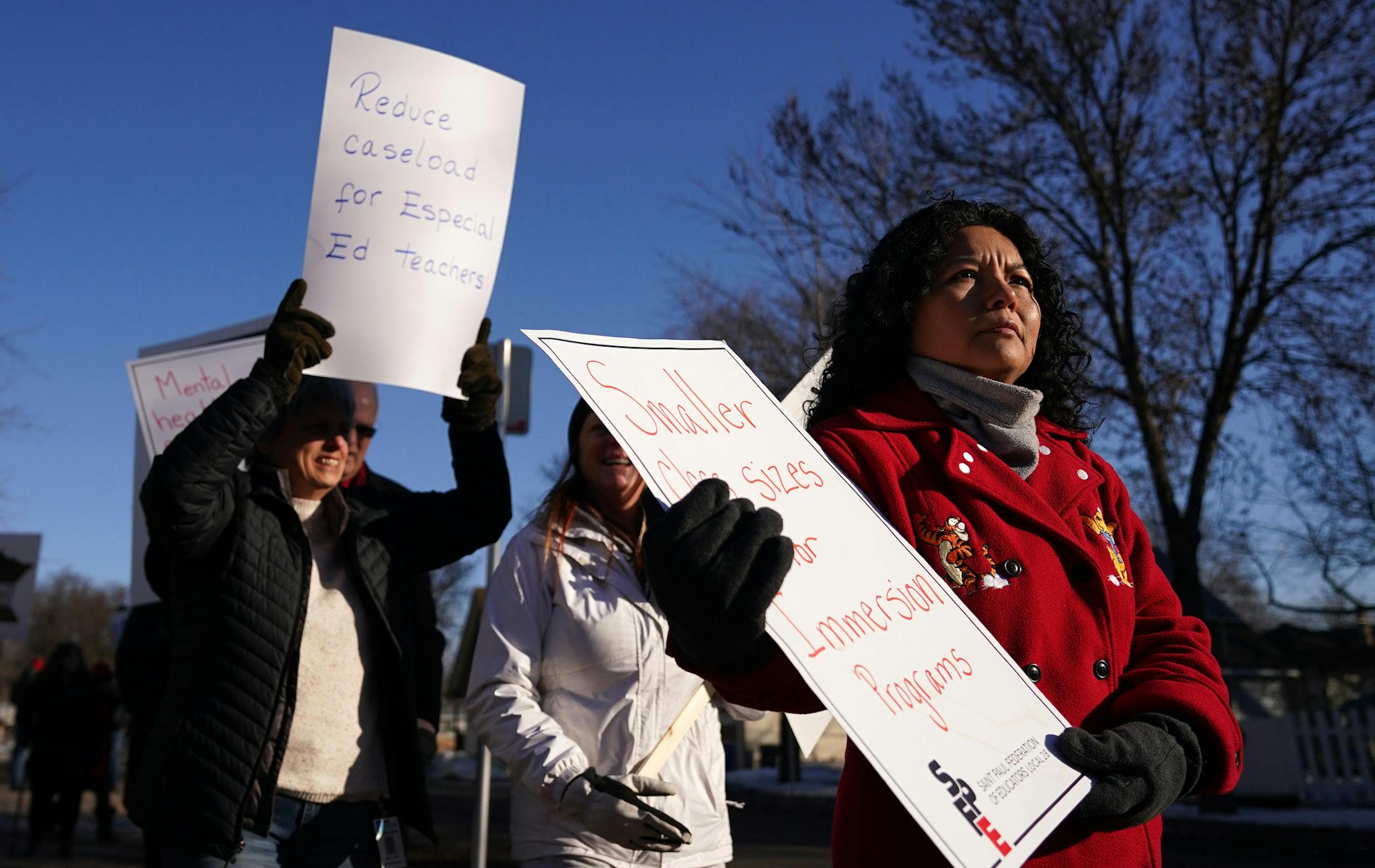 Second grade teacher Jeny Dohrer held a sign as she and fellow members of the St. Paul Federation of Educators braved the frigid temperatures while they picketed before school at Adams Spanish Immersion in St. Paul calling for a new contract with the creation of mental health teams in every building. ] ANTHONY SOUFFLE &#x2022; anthony.souffle@startribune.com Members of the St. Paul Federation of Educators picketed Wednesday, Feb. 26, 2020 before school at Adams Spanish Immersion in St. Paul, Min