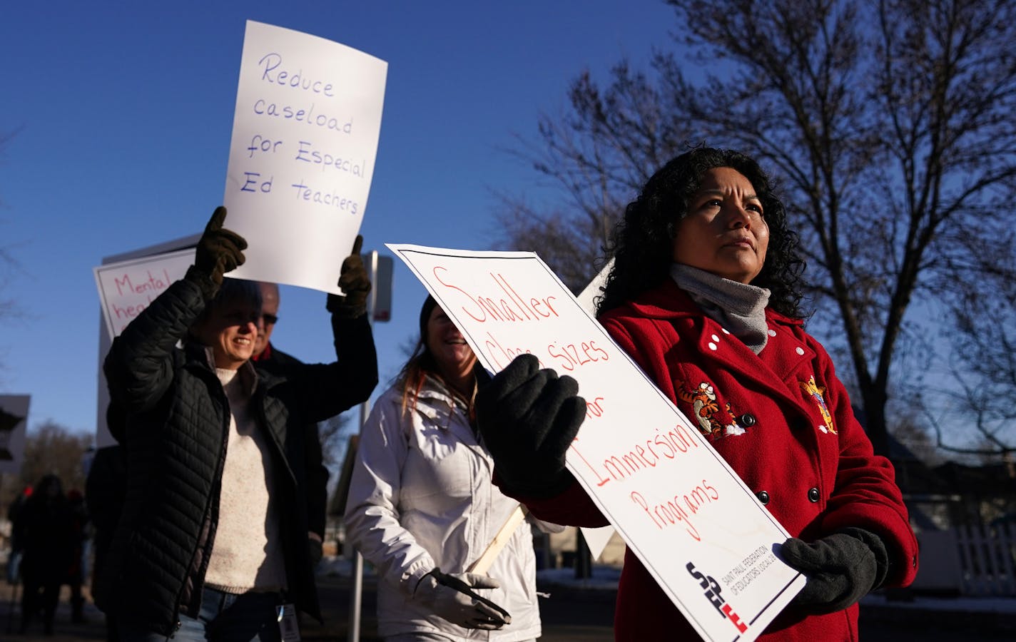 Second grade teacher Jeny Dohrer held a sign as she and fellow members of the St. Paul Federation of Educators braved the frigid temperatures while they picketed before school at Adams Spanish Immersion in St. Paul calling for a new contract with the creation of mental health teams in every building. ] ANTHONY SOUFFLE &#x2022; anthony.souffle@startribune.com Members of the St. Paul Federation of Educators picketed Wednesday, Feb. 26, 2020 before school at Adams Spanish Immersion in St. Paul, Min