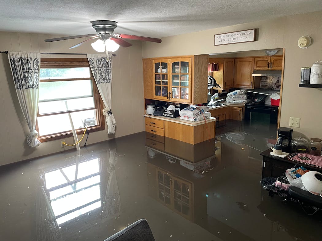 Chairs in Yuliana Guerrero's kitchen in Windom, Minn., float due to flooding of about three feet of water after heavy rain June 21 and 22, 2024.