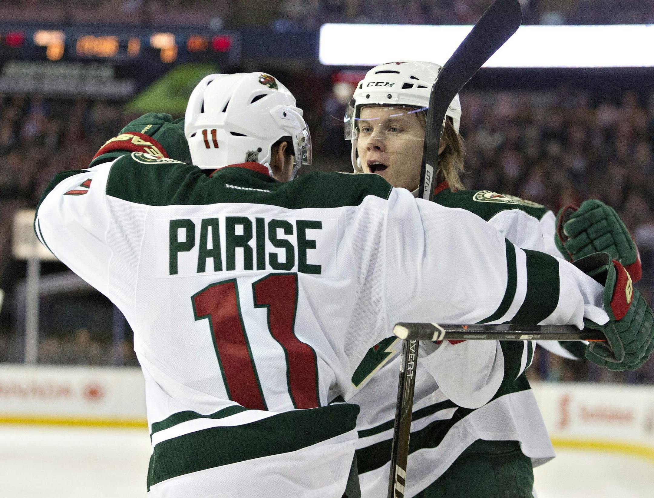 Minnesota Wild's Zach Parise (11) and Mikael Granlund (64) celebrate a goal against the Edmonton Oilers during first period NHL hockey action in Edmonton, Canada, Thursday, Feb. 27, 2014. (AP Photo/The Canadian Press, Jason Franson)