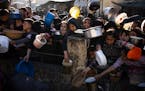 Palestinians line up for a free meal in Rafah, in the Gaza Strip, on March 12, 2024.