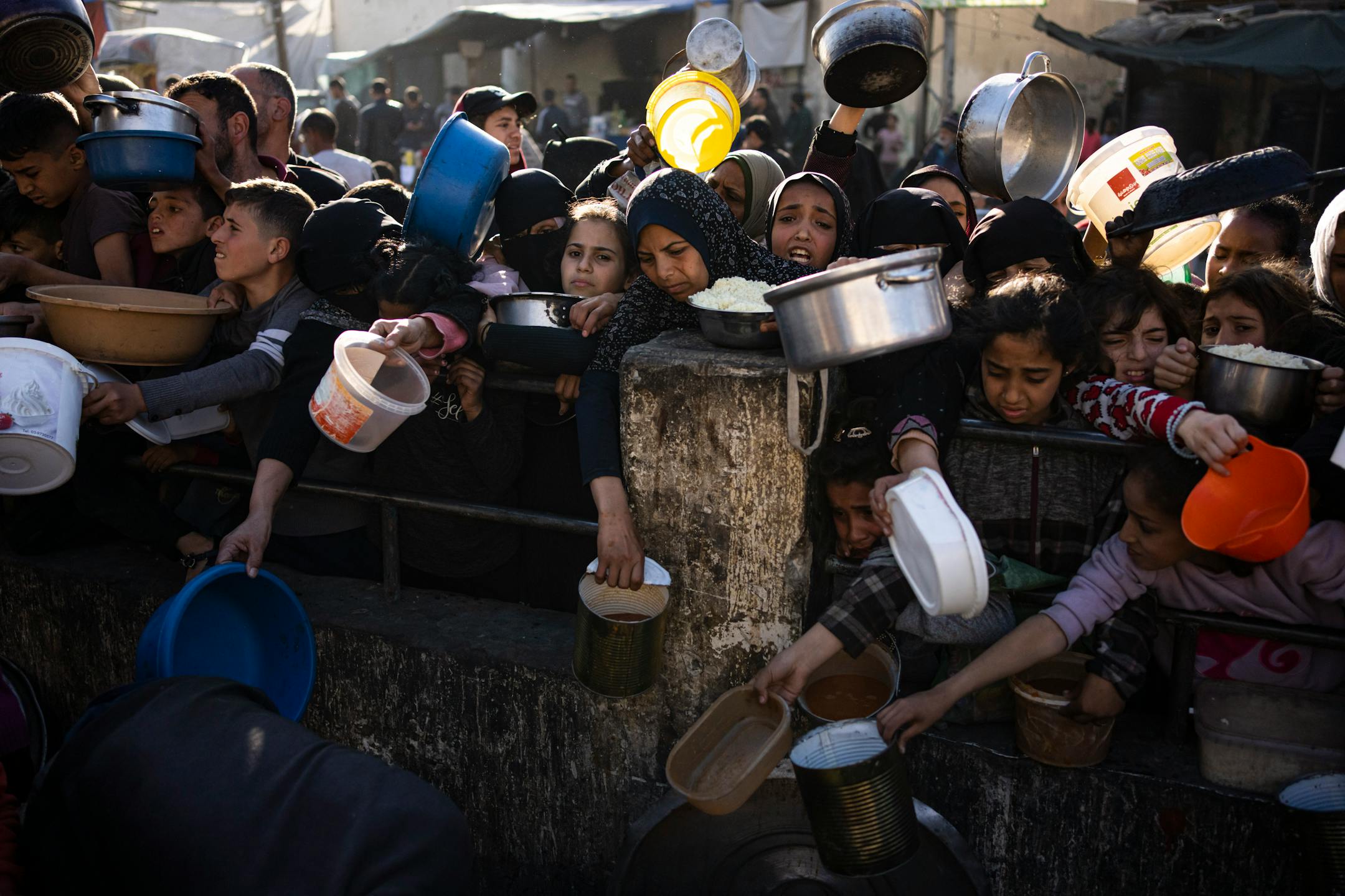 Palestinians line up for a free meal in Rafah, in the Gaza Strip, on March 12, 2024.