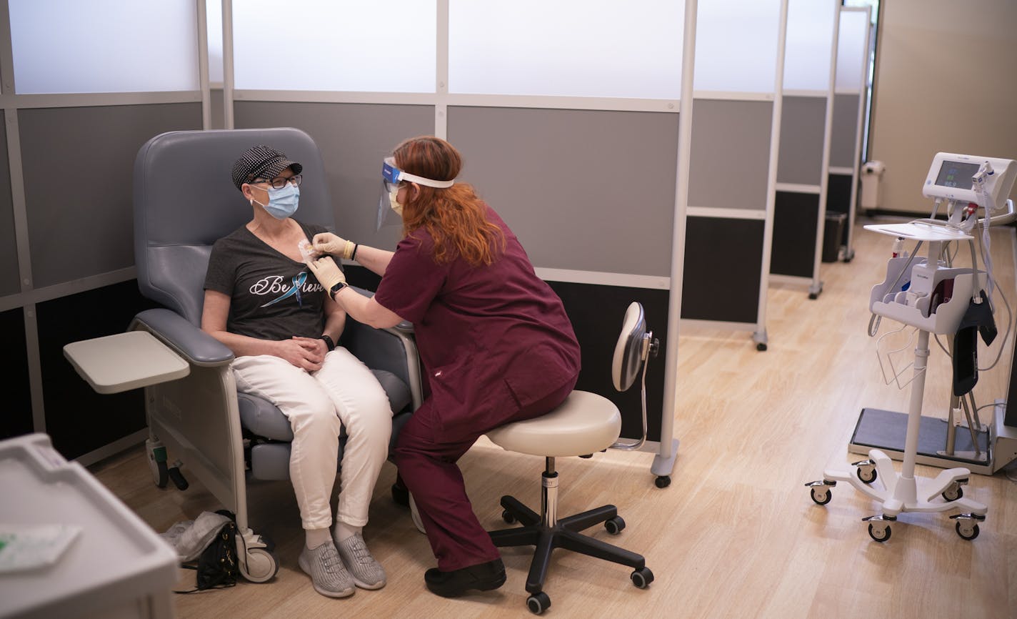 The stress "just piles on": On the eve of a chemotherapy appointment, Teri Woodhull had blood drawn by nurse Kim Rohde at M Health Fairview's Lab Draw Hub on Wednesday afternoon in Minneapolis. After the blood draw, Rohde secured the port that will be used for chemotherapy.