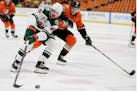 Minnesota Wild center Marcus Johansson, left, controls the puck against Anaheim Ducks right wing Jakob Silfverberg, right, during the first period of 