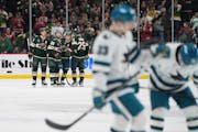 Wild players celebrate Ryan Hartman's long empty-net goal near the end of Thursday's 3-1 victory over San Jose at Xcel Energy Center.