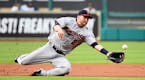 Minnesota Twins second baseman Brian Dozier (2) dives for an infield fly ball by Houston Astros' Jose Altuve in the first inning of a baseball game, M