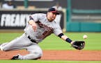 Minnesota Twins second baseman Brian Dozier (2) dives for an infield fly ball by Houston Astros' Jose Altuve in the first inning of a baseball game, M