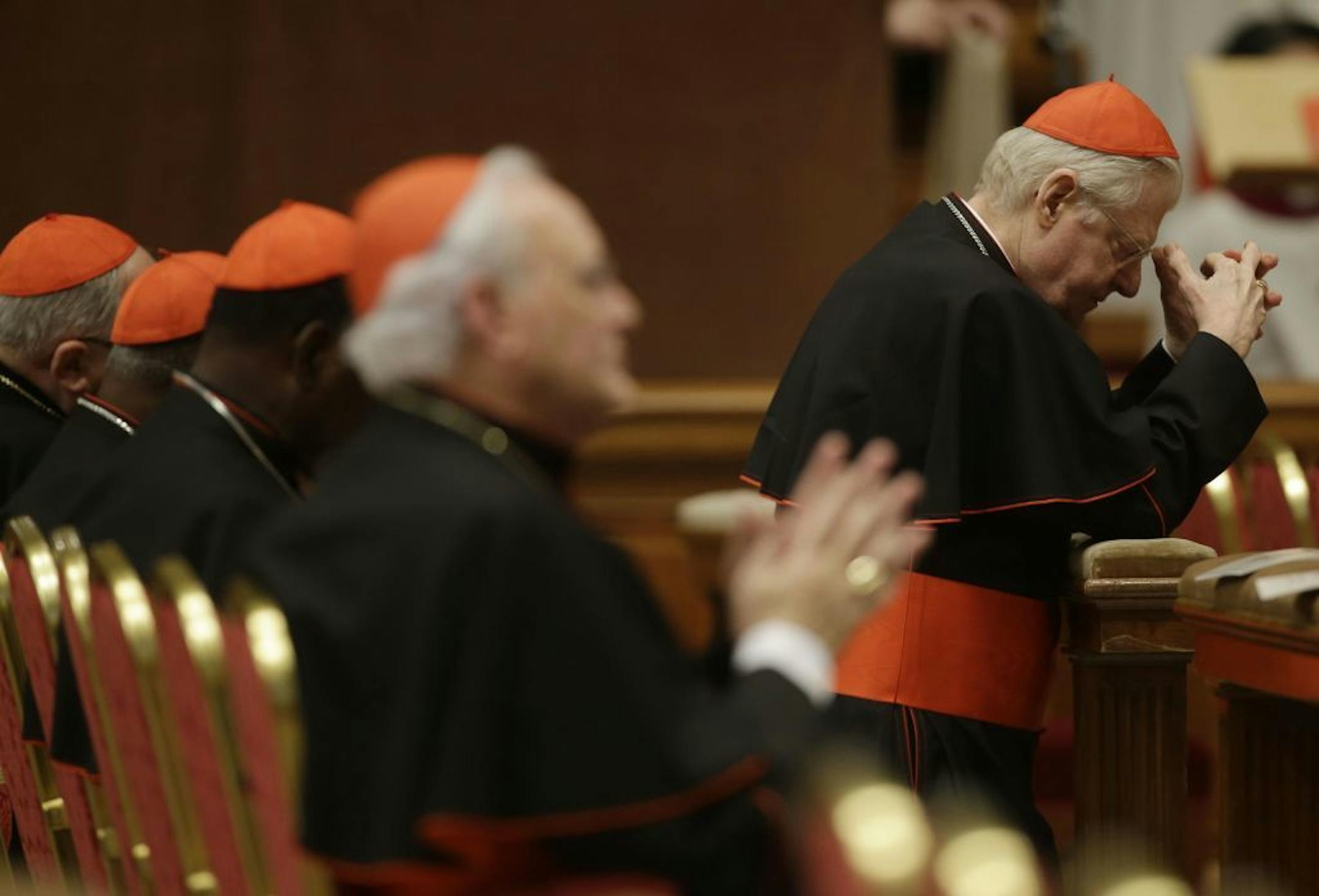 Cardinal Angelo Scola, top right, prays during a vespers celebration in St. Peter's Basilica at the Vatican, Wednesday, March 6, 2013. To illustrate that life is a journey, one of the Italian cardinals touted as a favorite to be the next pope doesn't just turn to the Scriptures, but also to Jack Kerouac and Cormac McCarthy. Angelo Scola, the archbishop of Milan, is seen as Italy's best chance at reclaiming the papacy, following back-to-back popes from outside the country that had a lock on the j