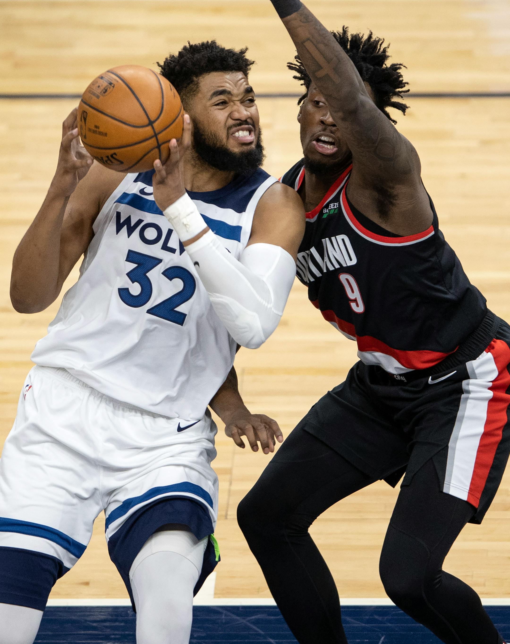 Karl-Anthony Towns (32) of the Minnesota Timberwolves was defended by Nassir Little (9) of the Portland Trailblazers in the first quarter.