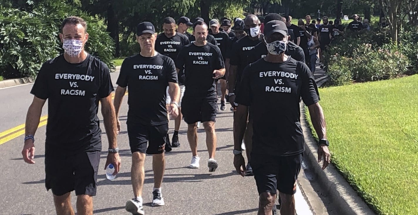 NBA referees march in support of players seeking an end to racial injustice. (AP Photo/Brian Mahoney)