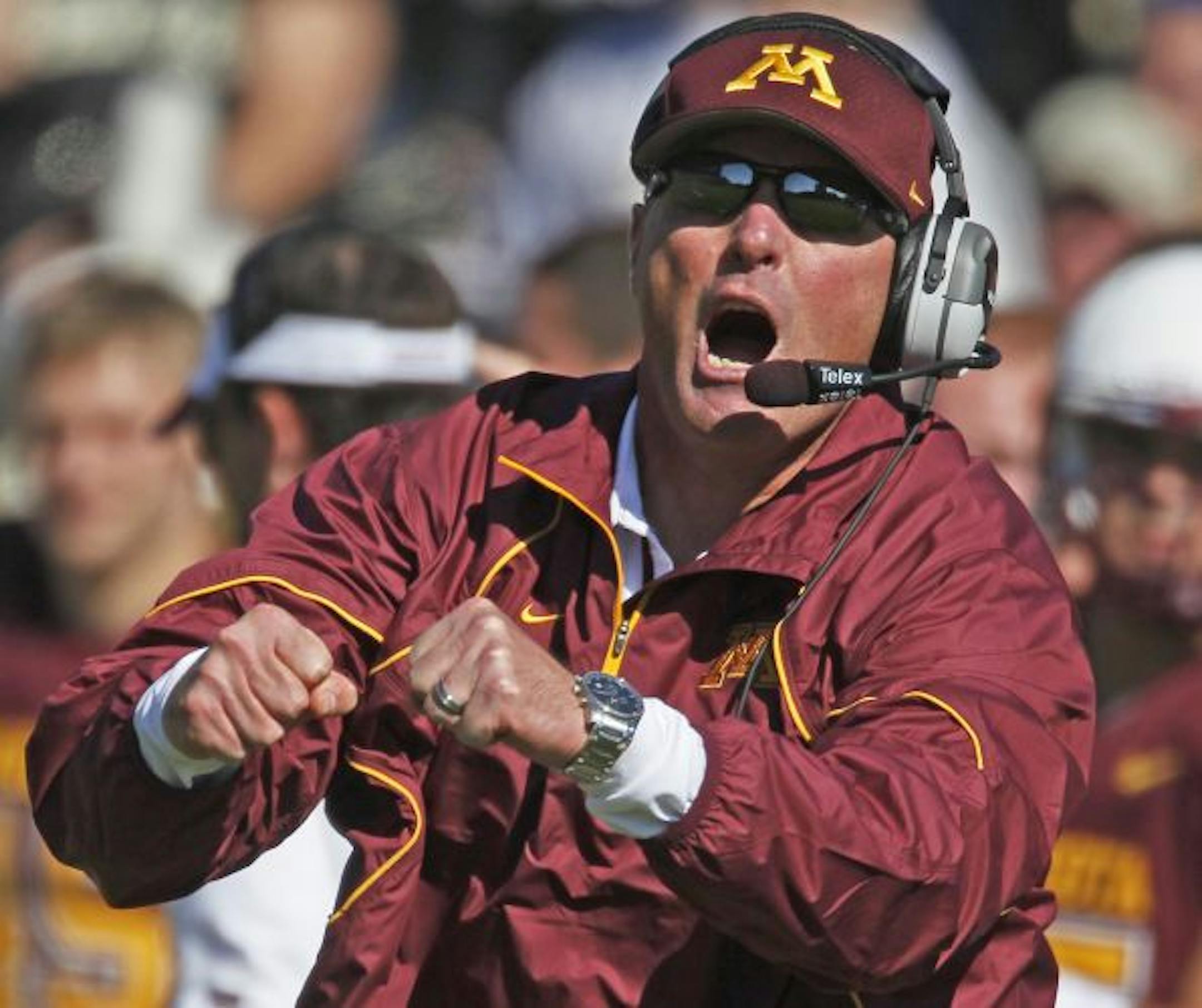 Gophers head coach Tim Brewster encouraged his players from the sidelines.